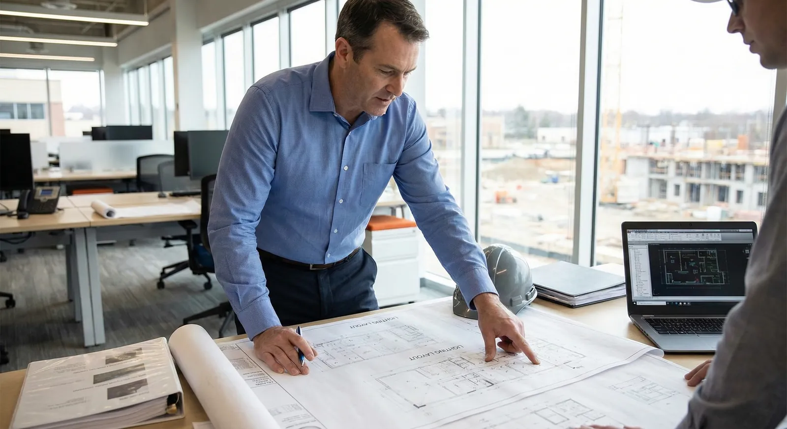 Consulting engineer reviewing project plans in an office